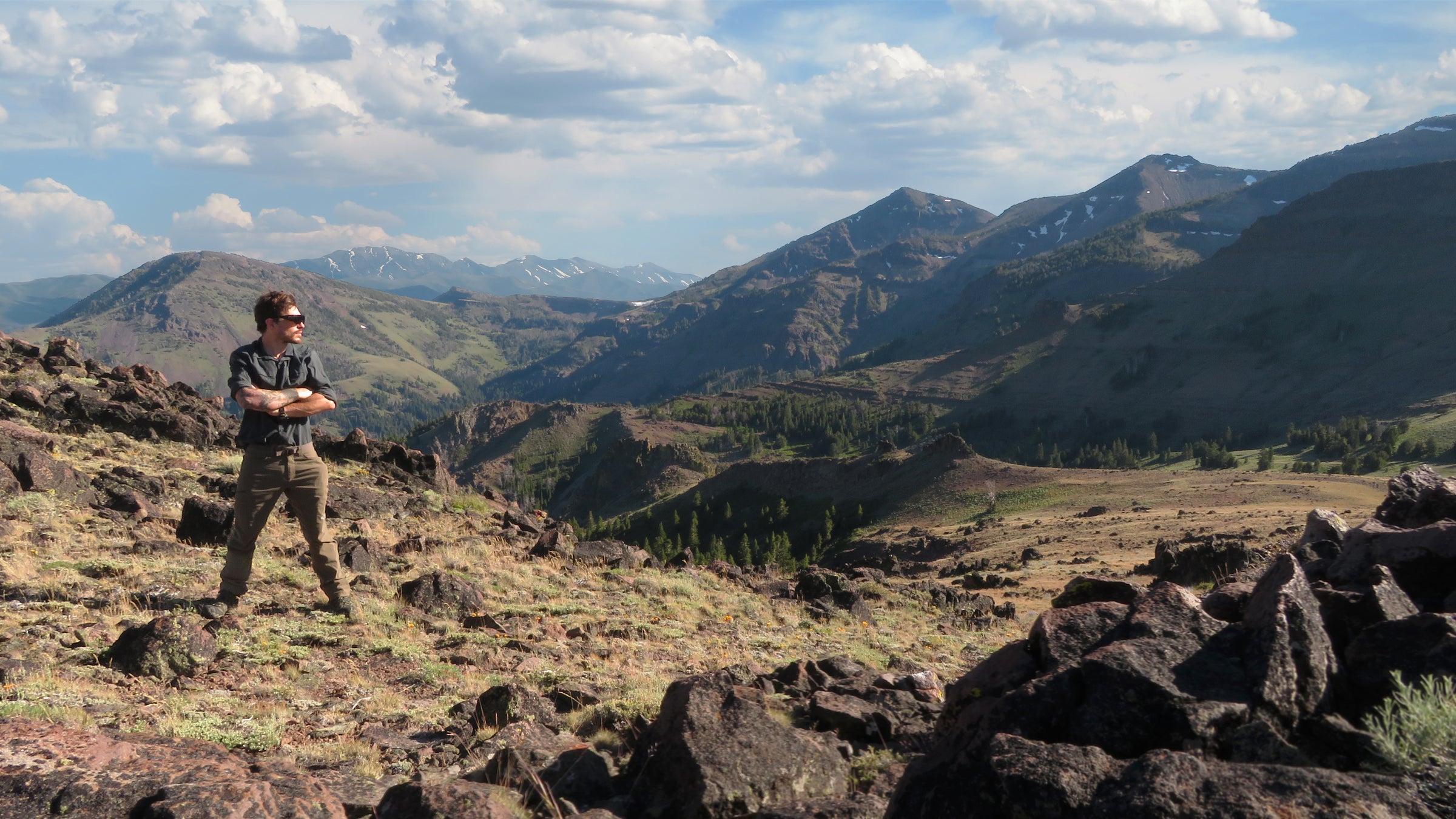 Brendan McCullough gazing over a vast mountain scene