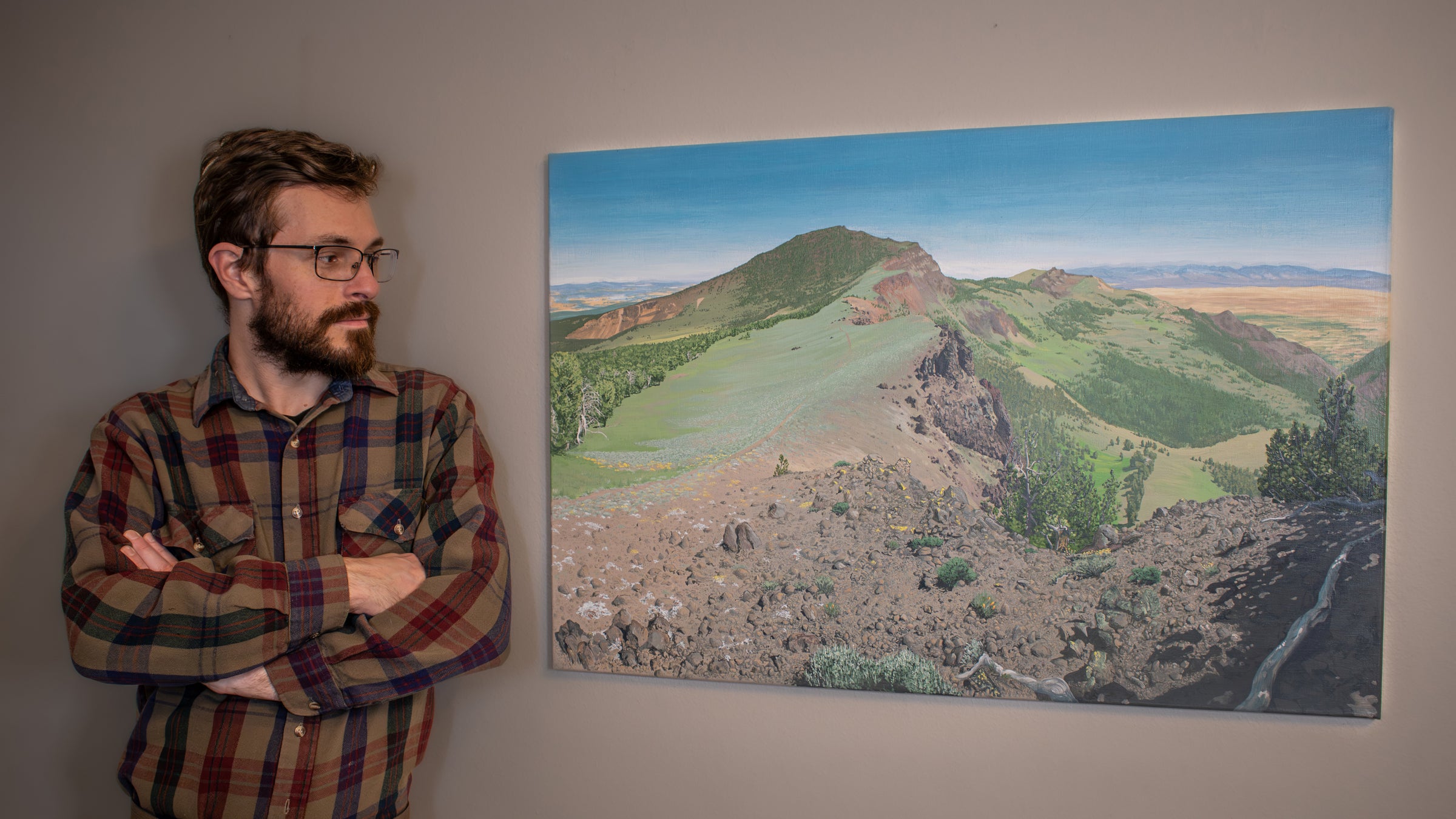 Brendan McCullough viewing an exhibit of his "Into the Distance" original painting